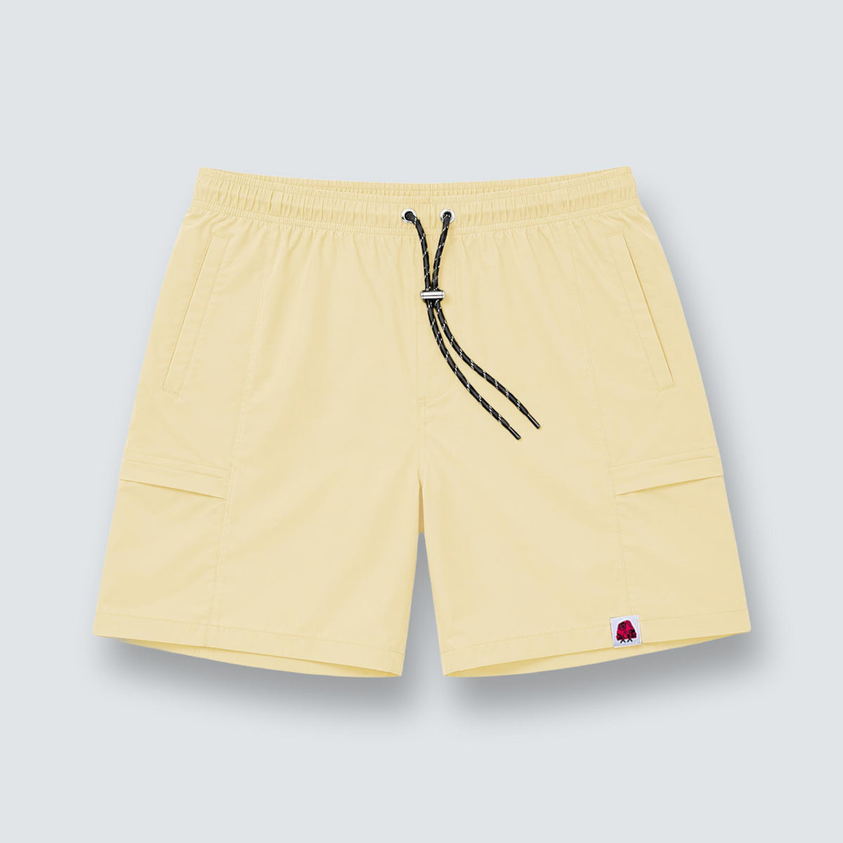 GALXBOY Essential Nylon Shorts in pale yellow, flat front view with black drawstring.